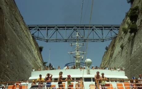 tourists on board watch as ship makes it way through the narrow canal