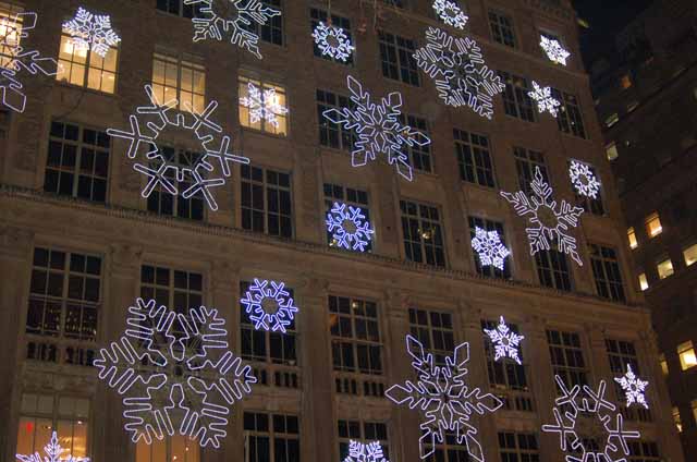 lighted snowflakes on side of building 