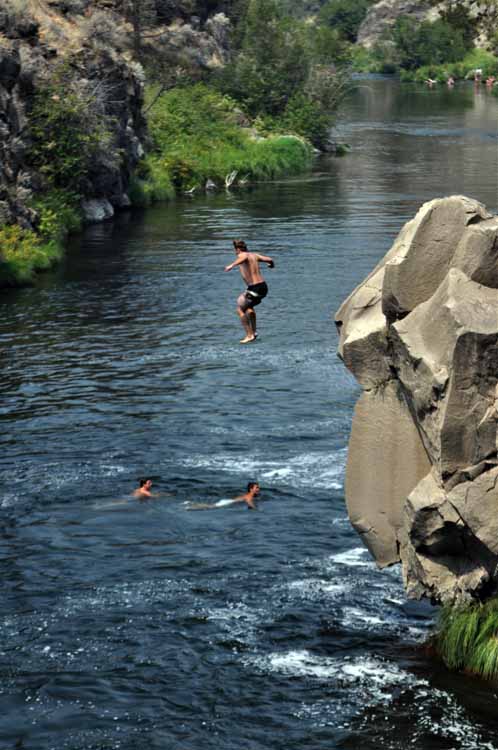 cliff jumping into river