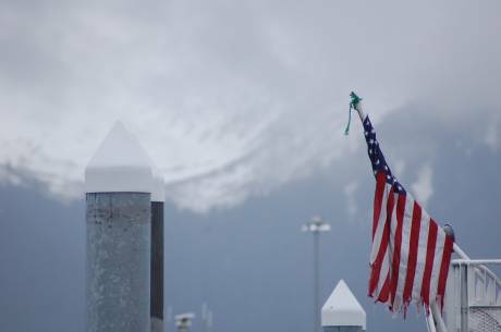 flag waves above harbor posts