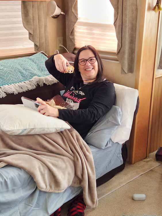 tina eating muffin on sofabed