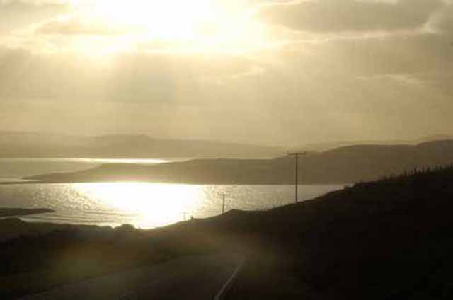 sun rays cast light over the water