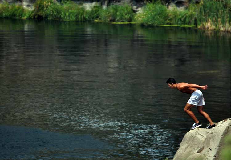 cliff-jumping into river